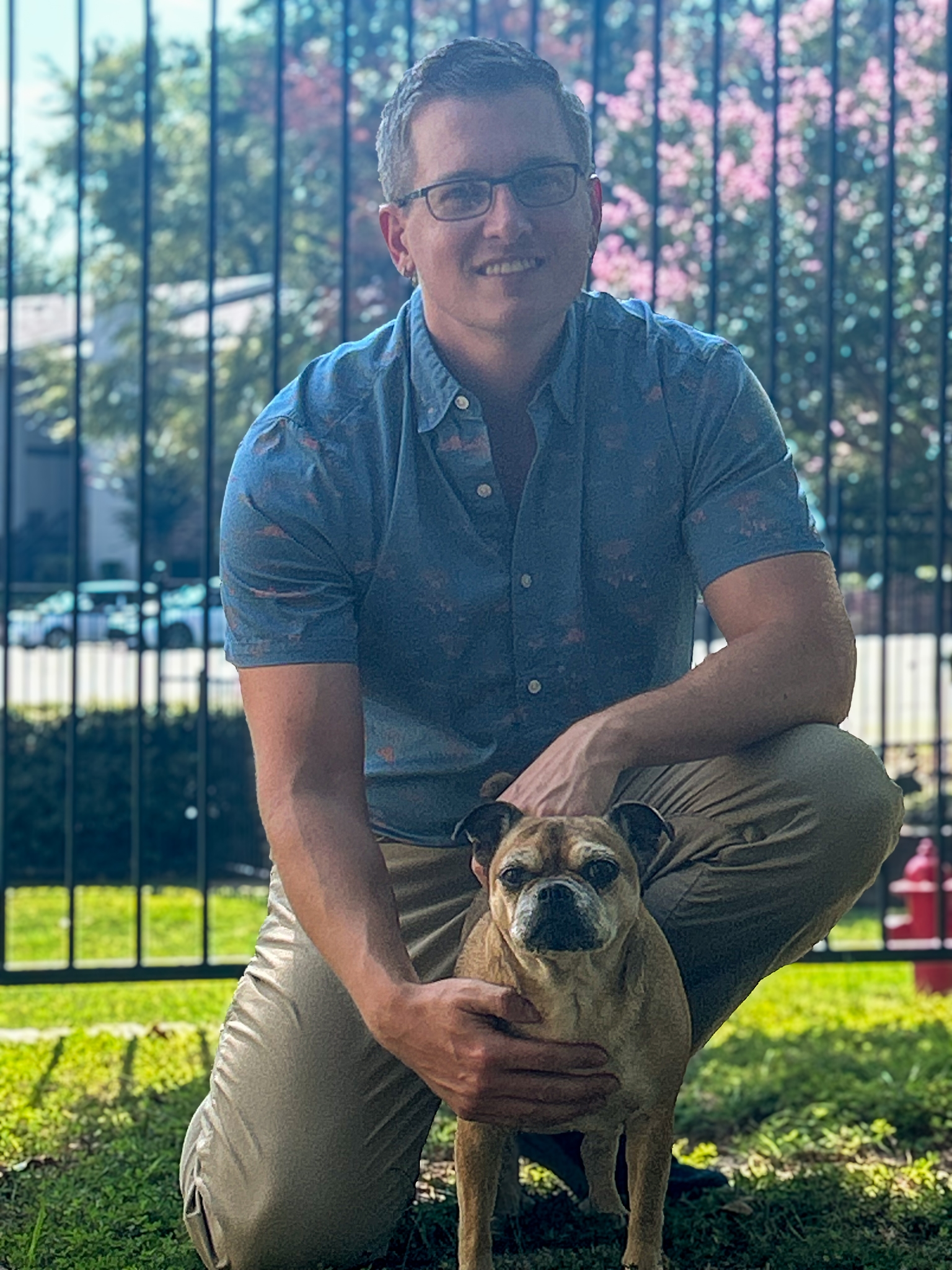 Picture of Ryan Moulliet kneeling with his dog